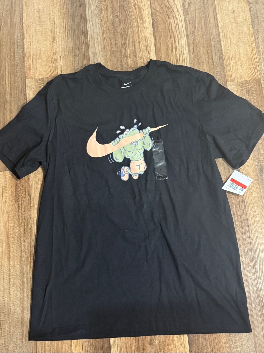 Nike Black Short-Sleeve Tee with Peach Swoosh and Green Character